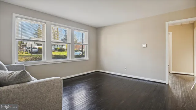 a living room with furniture and two window