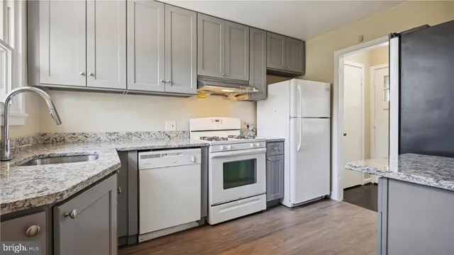a kitchen with a sink stove and refrigerator