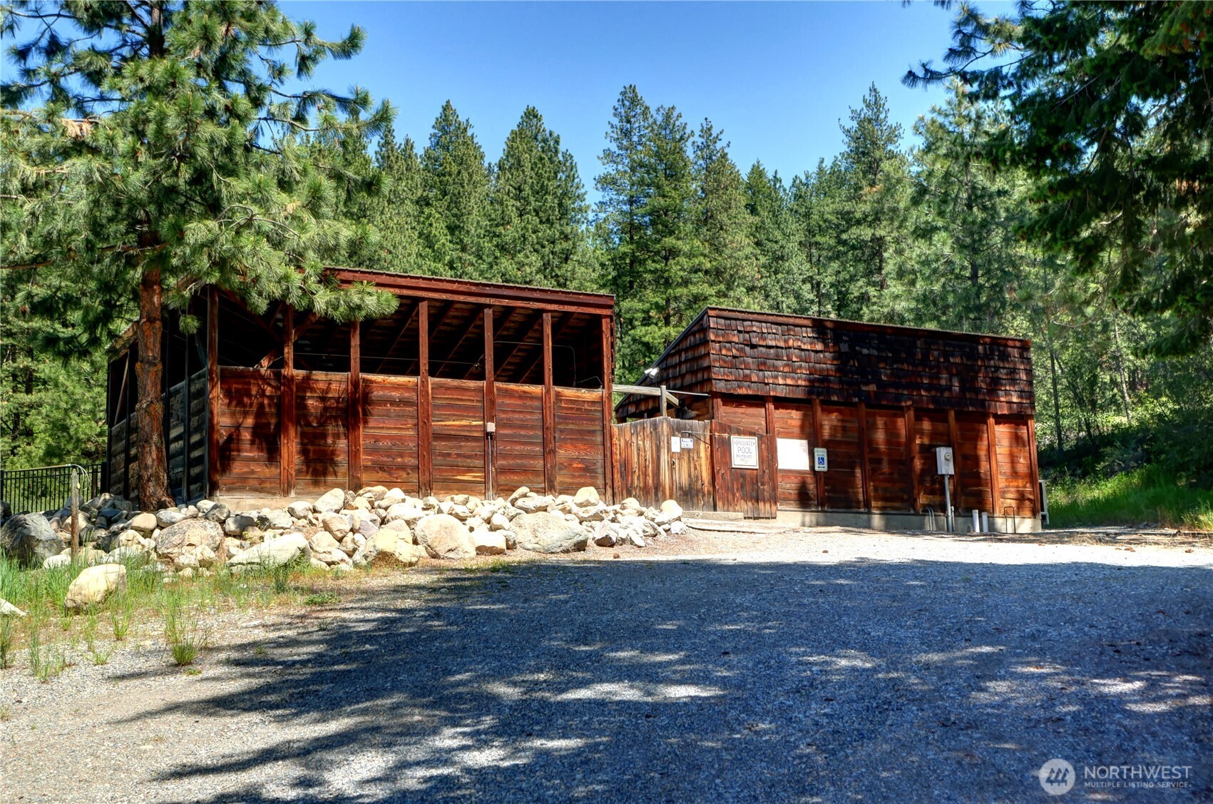 94 Homestead Road Winthrop, WA 98862 - Photo 22 of 26 a front view of a house with yard large tree and a yard