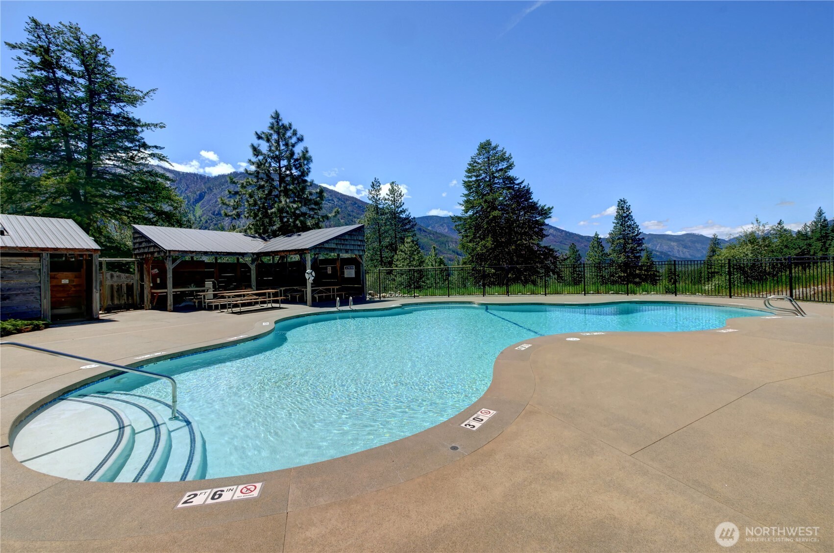 94 Homestead Road Winthrop, WA 98862 - Photo 25 of 26 a view of a house with swimming pool and a yard