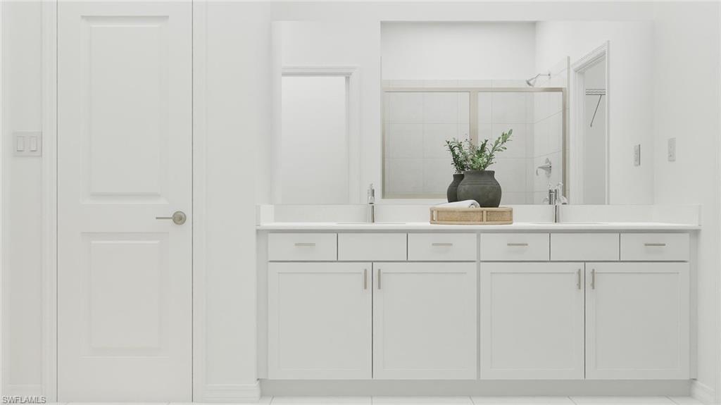 14895 Bluewater Road Babcock Ranch, FL 33982 - Photo 14 of 27 a bathroom with a sink a mirror and vanity