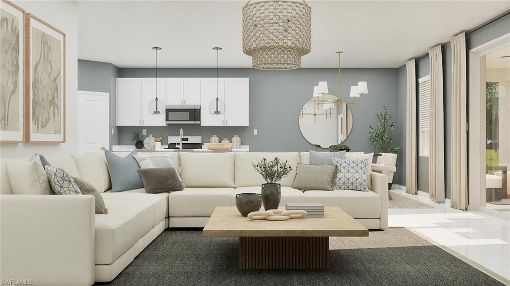 14895 Bluewater Road Babcock Ranch, FL 33982 - Photo 2 of 27 a living room with furniture a rug and a lamp
