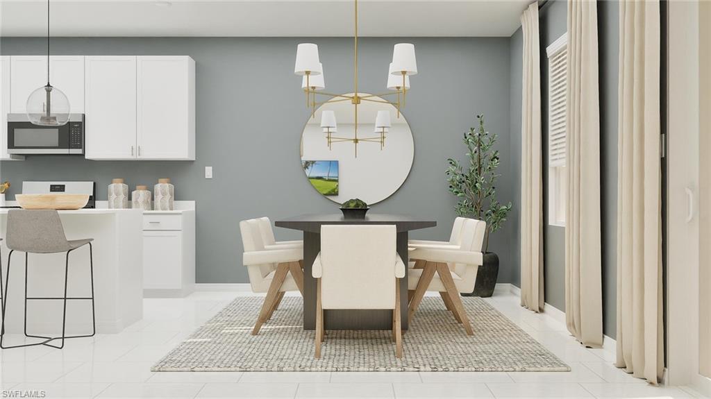 14895 Bluewater Road Babcock Ranch, FL 33982 - Photo 7 of 27 a view of a dining room with furniture and wooden floor