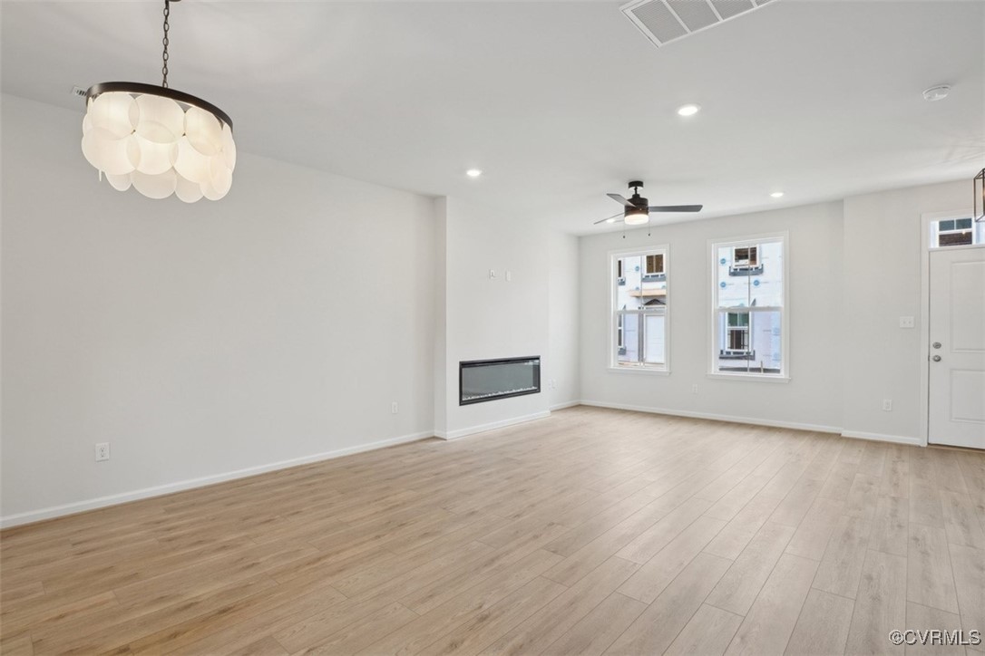212 That Way Midlothian, VA 23114 - Photo 13 of 37 an empty room with wooden floor and kitchen view