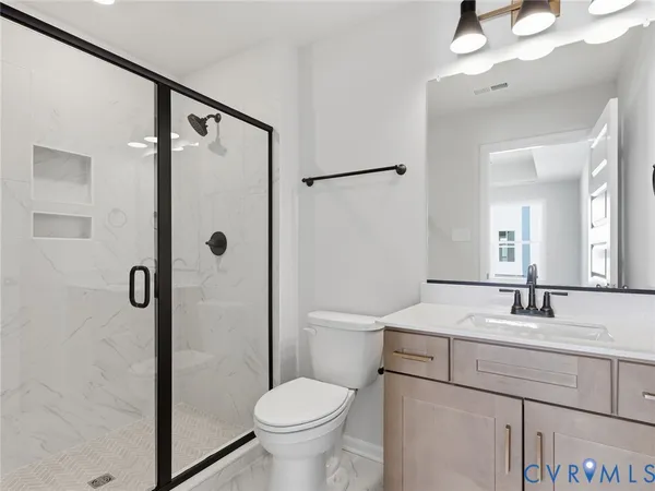 a bathroom with a sink toilet and shower