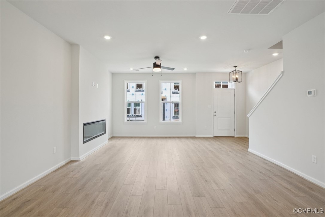 212 That Way Midlothian, VA 23114 - Photo 2 of 37 an empty room with wooden floor and a ceiling fan