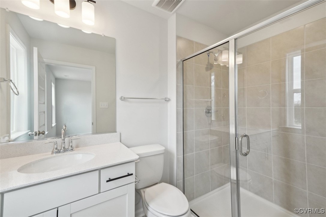 212 That Way Midlothian, VA 23114 - Photo 22 of 37 a bathroom with a sink toilet vanity and shower