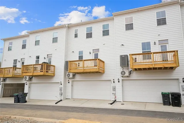 front view of a brick house with a yard