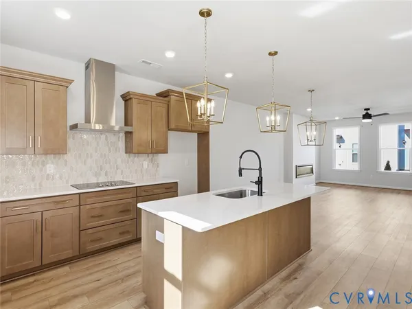 a kitchen with a sink cabinets and wooden floor