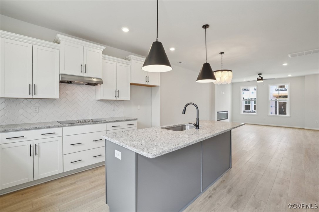 212 That Way Midlothian, VA 23114 - Photo 6 of 37 a kitchen with stainless steel appliances granite countertop a sink a stove a refrigerator and white cabinets with wooden floor