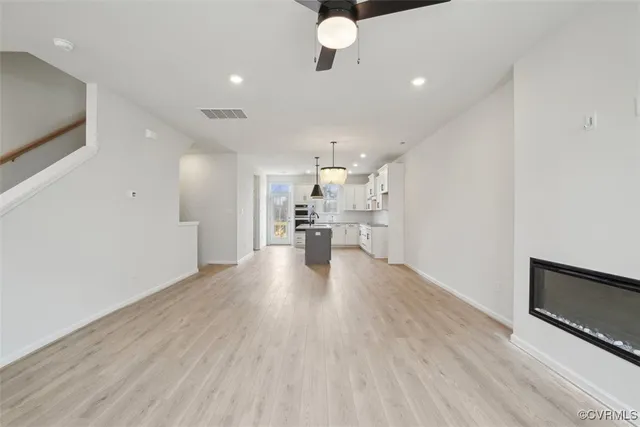 a view of a kitchen with a sink and wooden floor