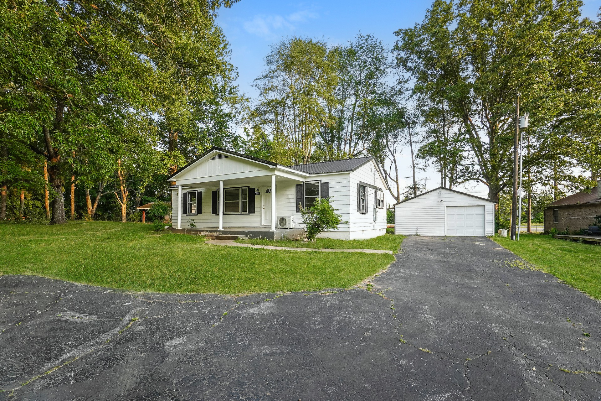 231 Foston Chapel Road Hopkinsville, KY 42240 - Photo 7 of 20 a front view of a house with a garden and trees