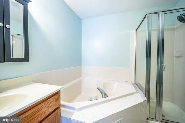 a bathroom with a bathtub and a sink