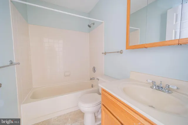 a bathroom with a sink a toilet and bathtub