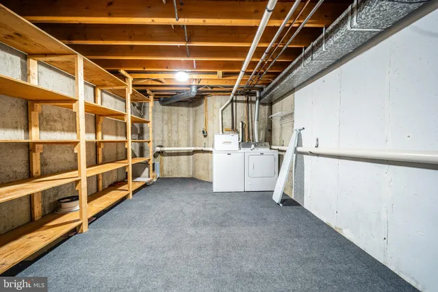 a view of an empty room with white cabinets
