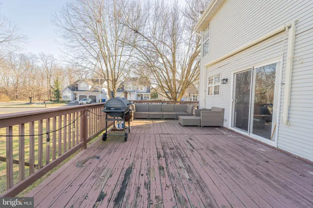 a view of a deck with table and chairs and wooden floor