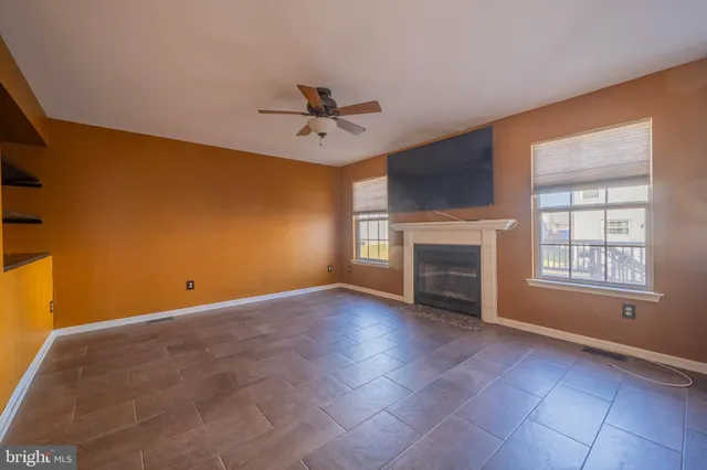 a view of empty room with a fireplace