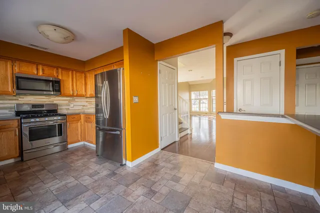 a view of a kitchen with a stove cabinets and a kitchen