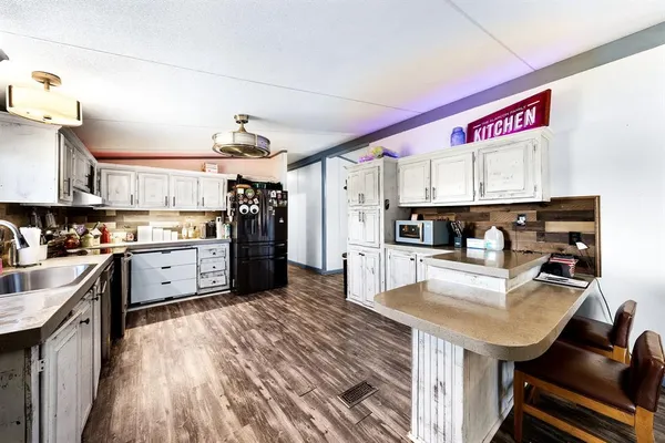 a kitchen with stainless steel appliances granite countertop a stove sink and cabinets
