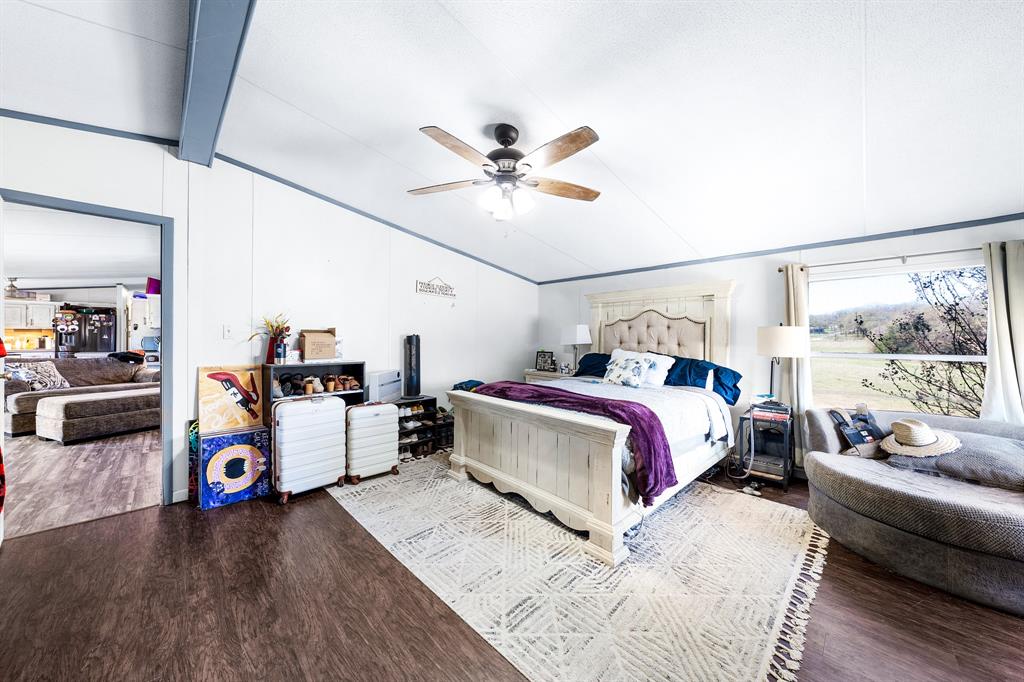1536 New Hope Road Boyd, TX 76023 - Photo 32 of 40 a bedroom with a bed and wooden floor