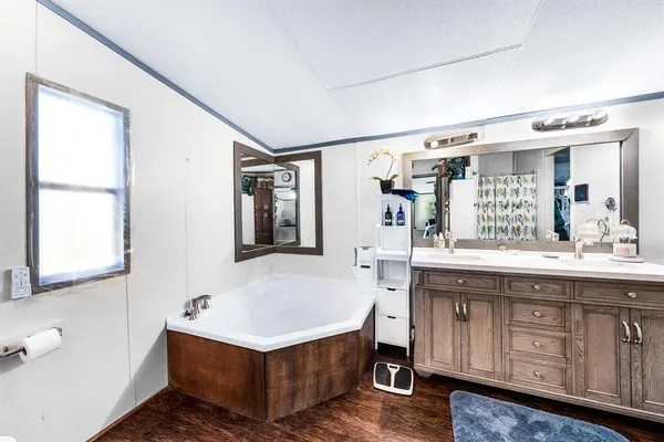 a bathroom with a sink double vanity granite and a mirror