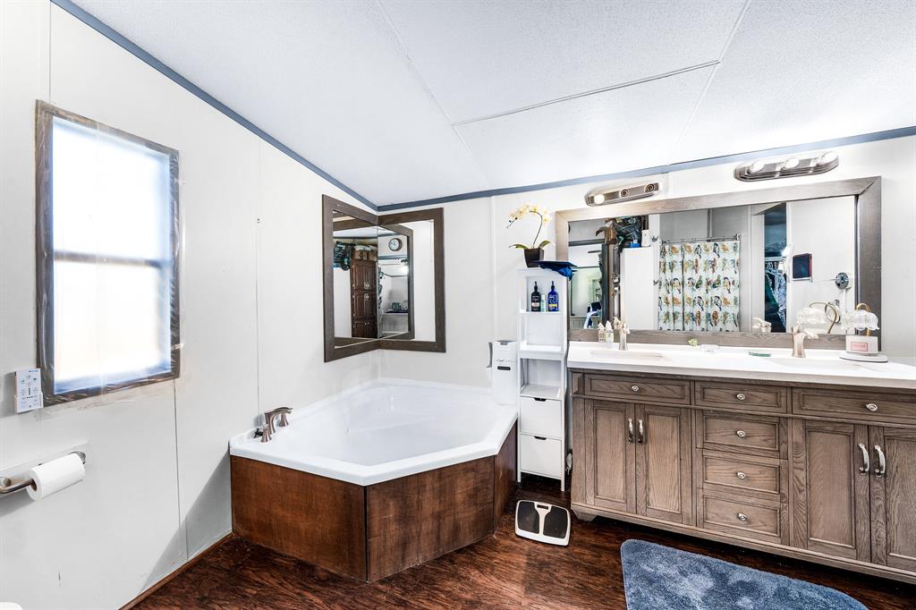 1536 New Hope Road Boyd, TX 76023 - Photo 34 of 40 a bathroom with a tub sink and mirror