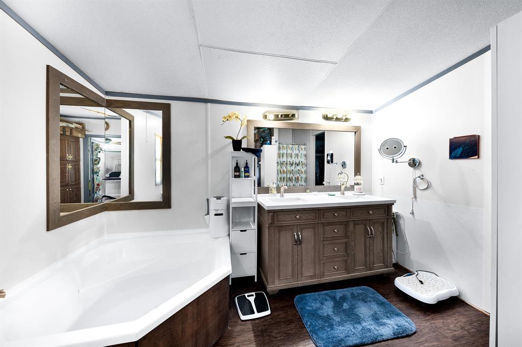 1536 New Hope Road Boyd, TX 76023 - Photo 35 of 40 a bathroom with a sink double vanity granite and a mirror