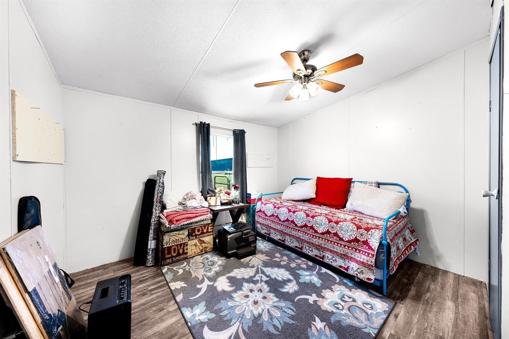 1536 New Hope Road Boyd, TX 76023 - Photo 37 of 40 a bedroom with a bed and wooden floor