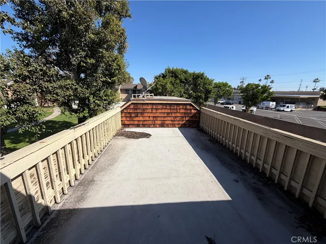 a balcony with view of trees in front of it