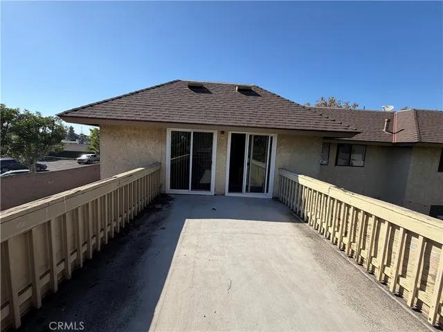 a view of a house with wooden fence