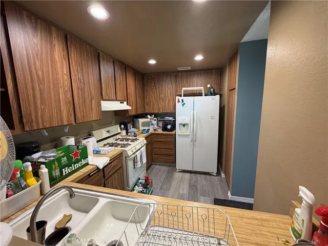 a kitchen with a refrigerator and a sink