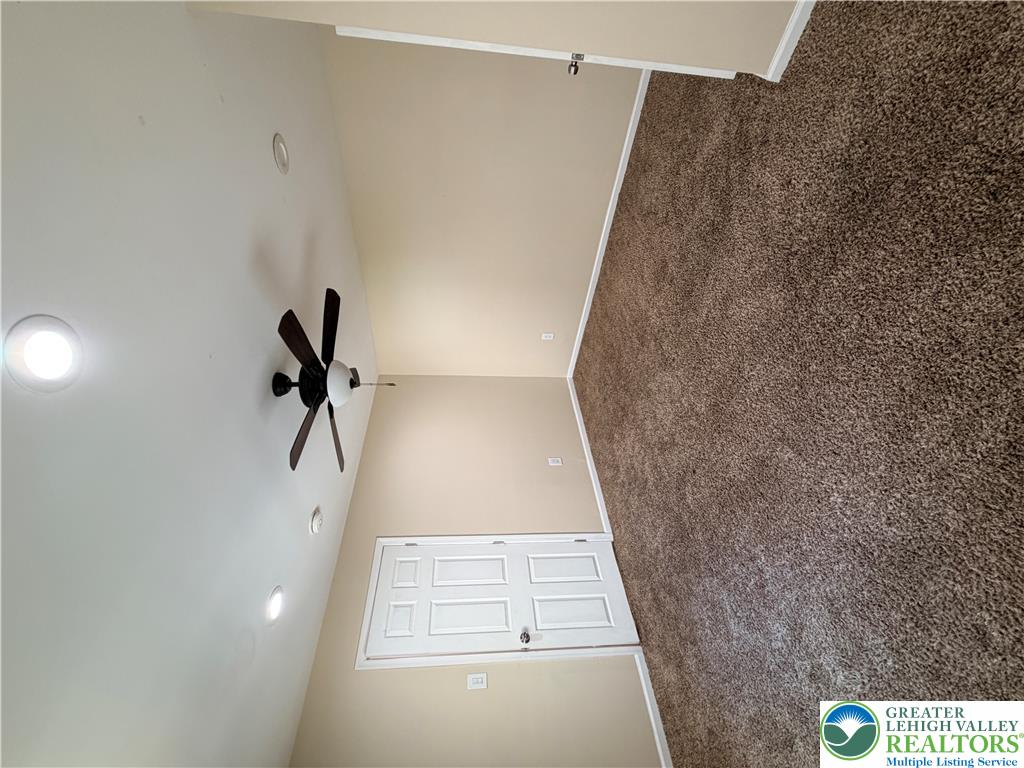 718 Ferry Street Easton, PA 18042 - Photo 15 of 37 Plush carpeting and a modern ceiling fan elevate this tranquil sleeping space.