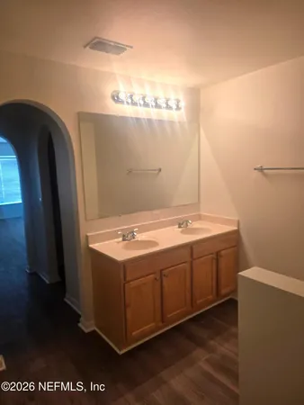 a bathroom with a double vanity sink and a mirror
