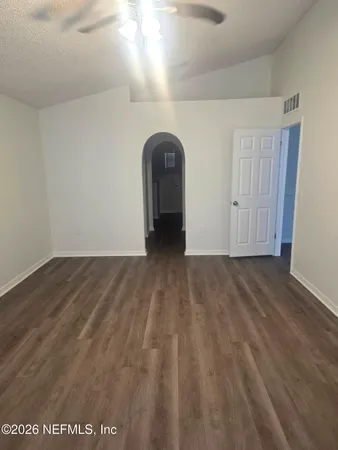 a view of a room with wooden floor