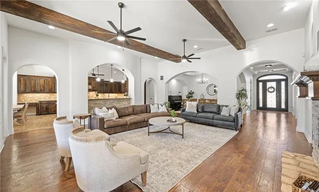 a living room with fireplace furniture and a large window