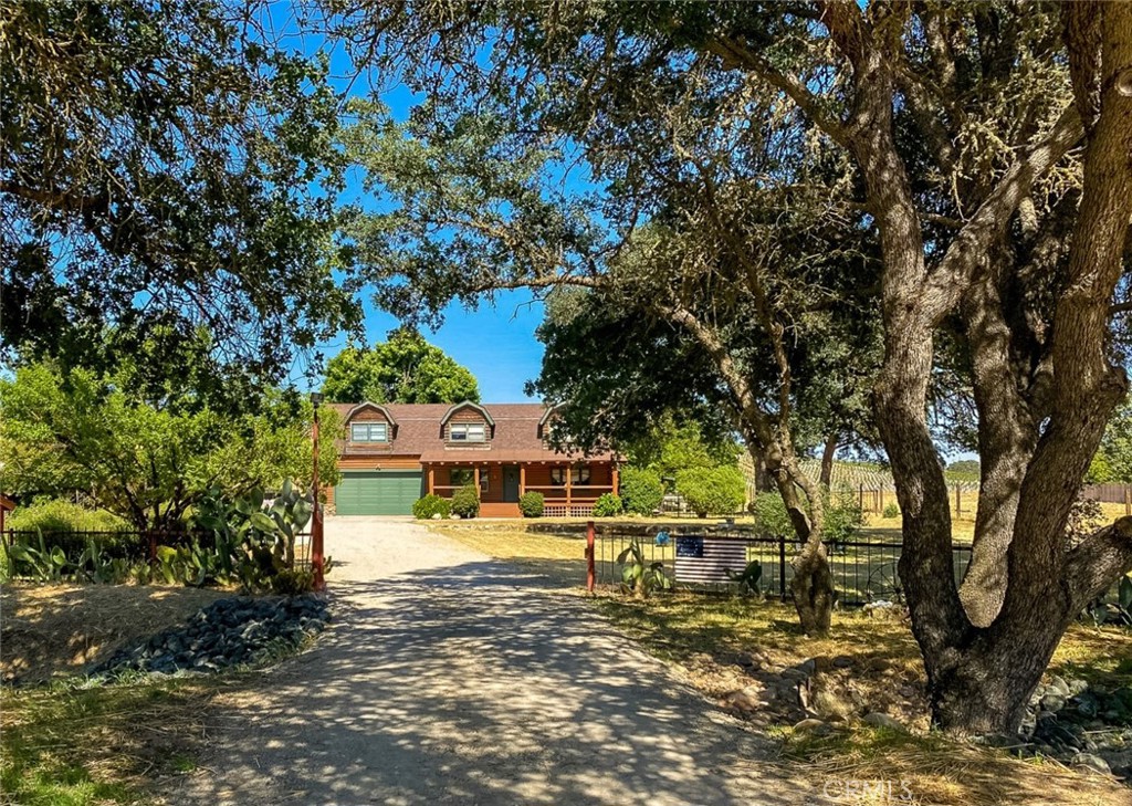 a view of a house with a large trees