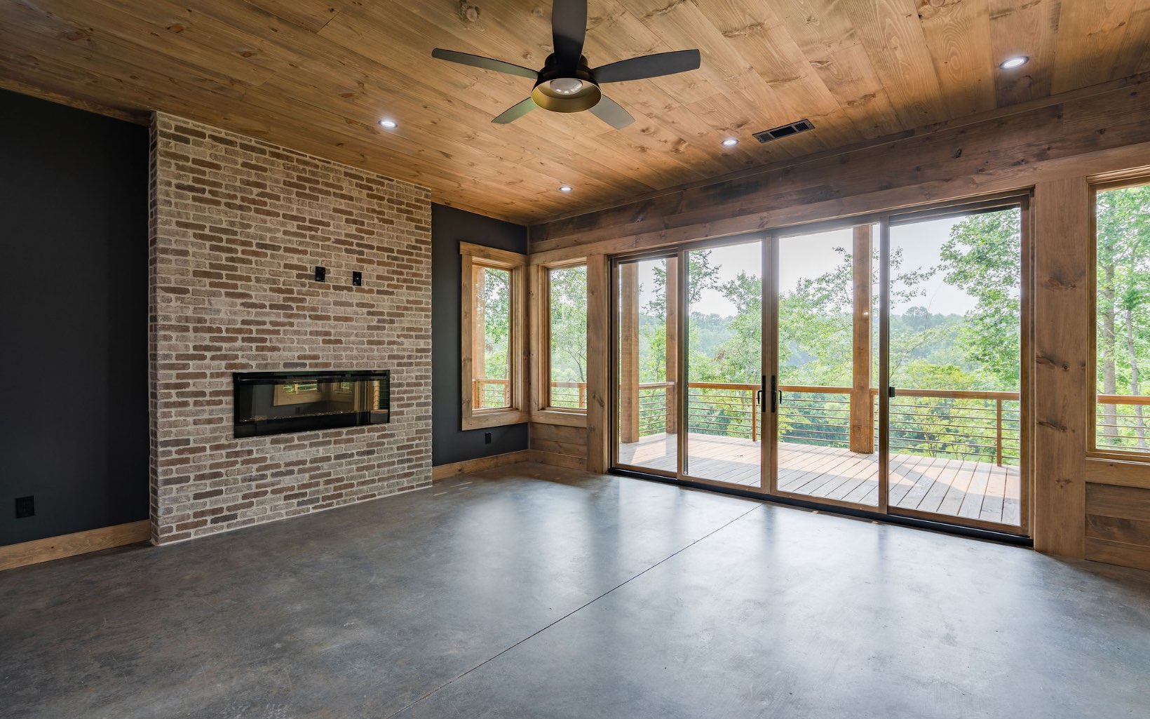 140 Watkins Farm Road Blue Ridge, GA 30513 - Photo 46 of 63 a view of an empty room with windows and a fireplace