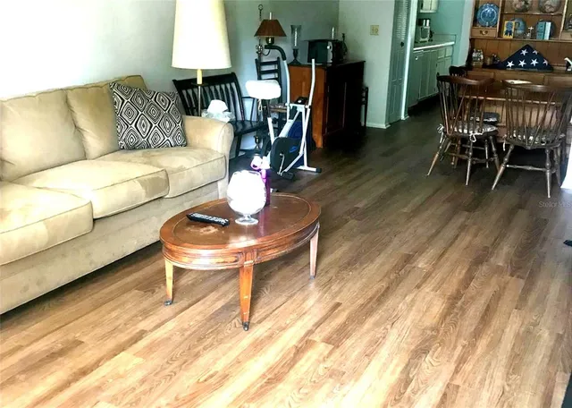 a living room with furniture a wooden floor and a table