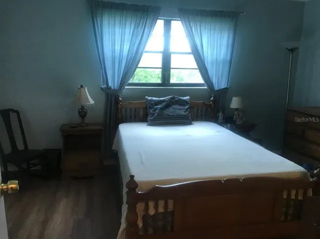 a bed sitting in a bedroom next to a window