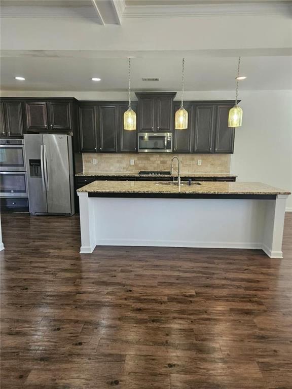 90 Partridge Drive Covington, GA 30016 - Photo 11 of 38 a view of a kitchen with kitchen island a sink stainless steel appliances and cabinets