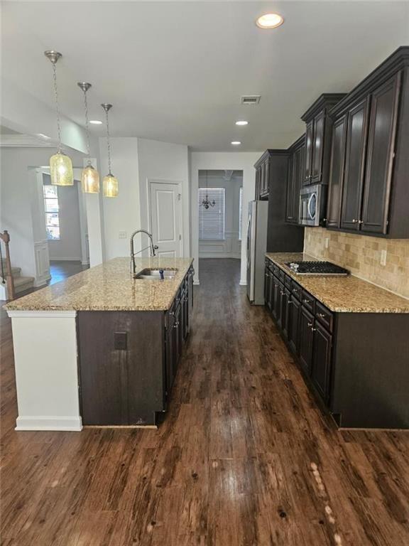 90 Partridge Drive Covington, GA 30016 - Photo 13 of 38 a kitchen with kitchen island granite countertop a sink and wooden cabinets