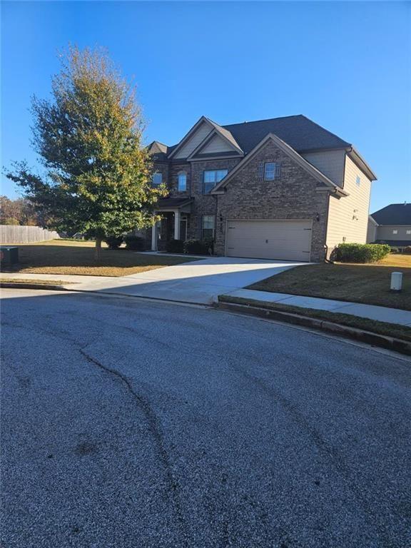 90 Partridge Drive Covington, GA 30016 - Photo 2 of 38 a front view of a house with a yard