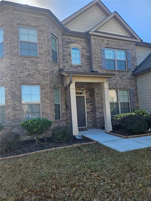 90 Partridge Drive Covington, GA 30016 - Photo 4 of 38 a front view of a house with garden