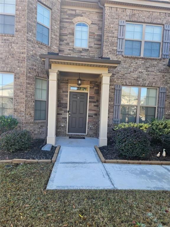 90 Partridge Drive Covington, GA 30016 - Photo 6 of 38 a front view of a house with garden
