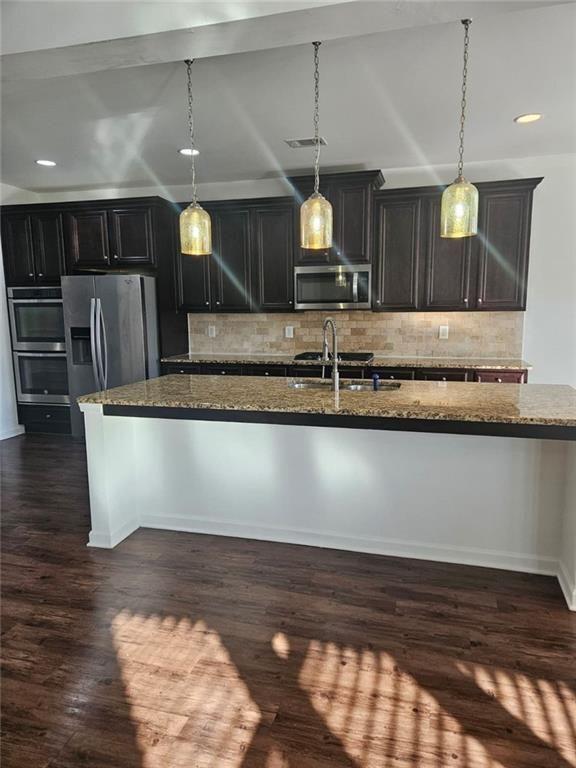 90 Partridge Drive Covington, GA 30016 - Photo 9 of 38 a view of kitchen with stainless steel appliances wooden floor sink and wooden floor