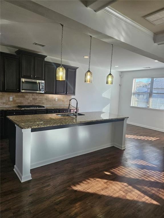 90 Partridge Drive Covington, GA 30016 - Photo 10 of 38 a kitchen with kitchen island a counter top a stove and a wooden floors