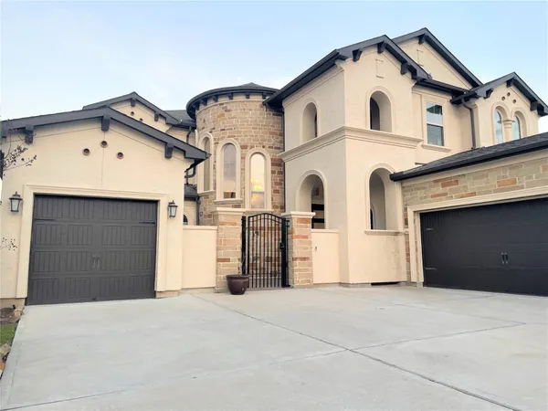 a view of a white house with a garage and windows