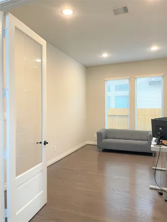 a view of a room with window wooden floor and chandelier