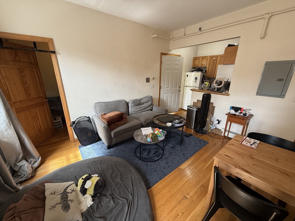 712 Commonwealth Avenue, Unit 1 Boston, MA 02215 - Photo 2 of 7 a living room with furniture and a wooden floor
