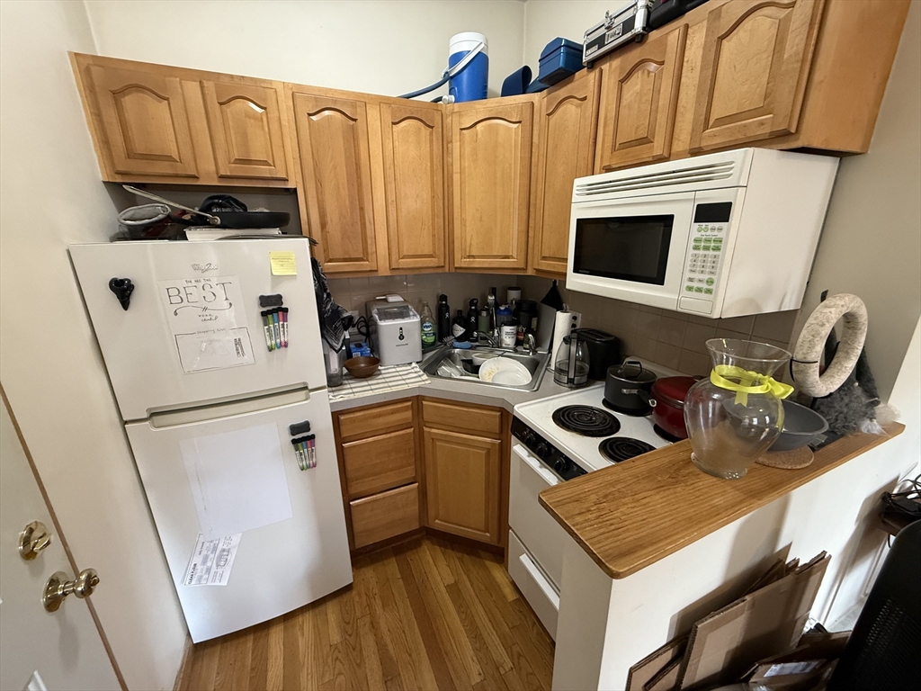 712 Commonwealth Avenue, Unit 1 Boston, MA 02215 - Photo 6 of 7 a kitchen with stainless steel appliances a stove a microwave and a refrigerator